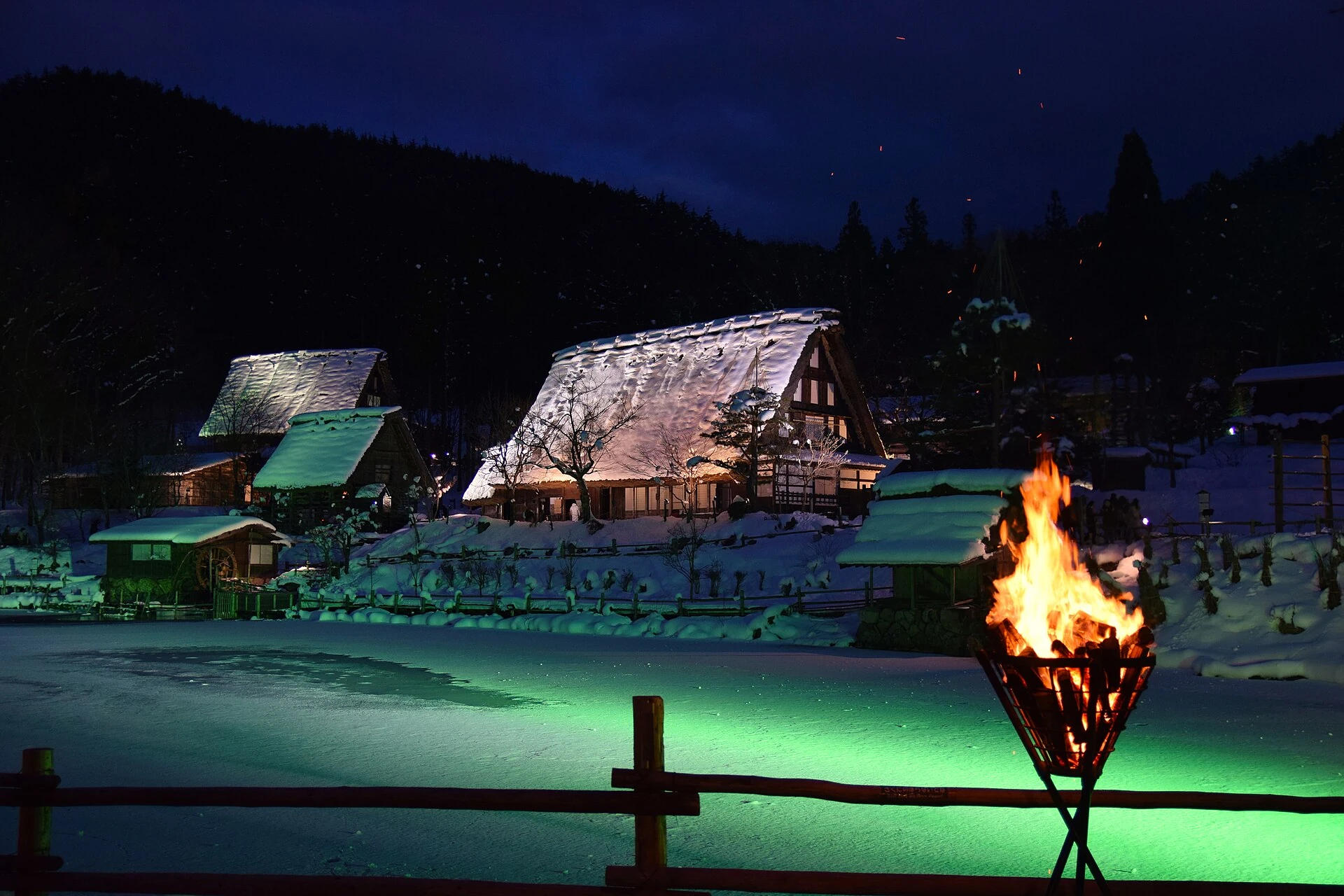 Snowy traditional houses at Hida Folk Village illuminated at night