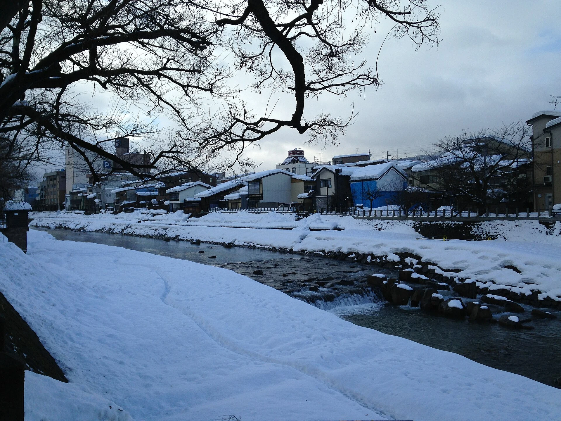 Morning market along the snow-lined Miyagawa River in Takayama
