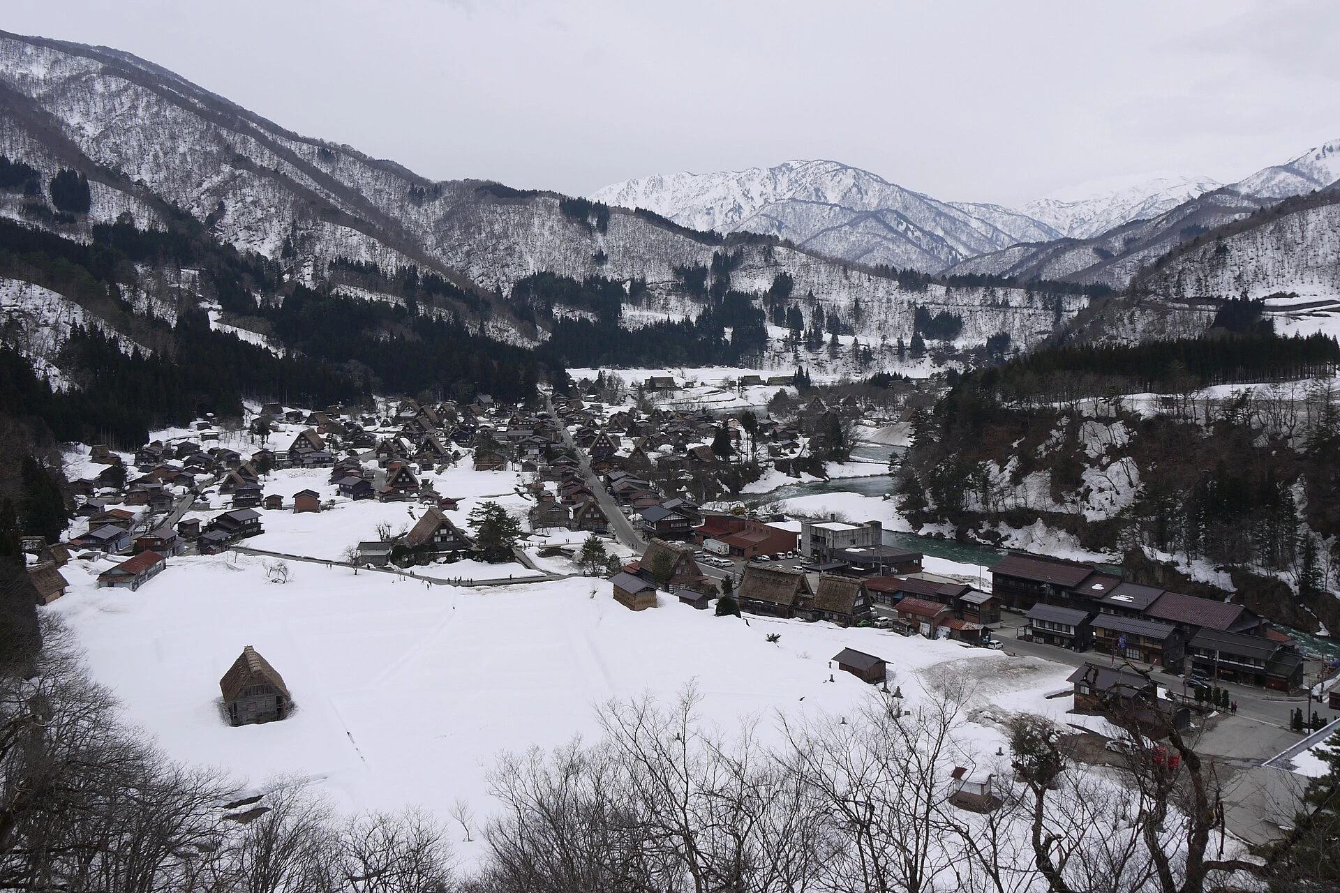 A panorama of Shirakawa-go surrounded by snowy mountain slopes